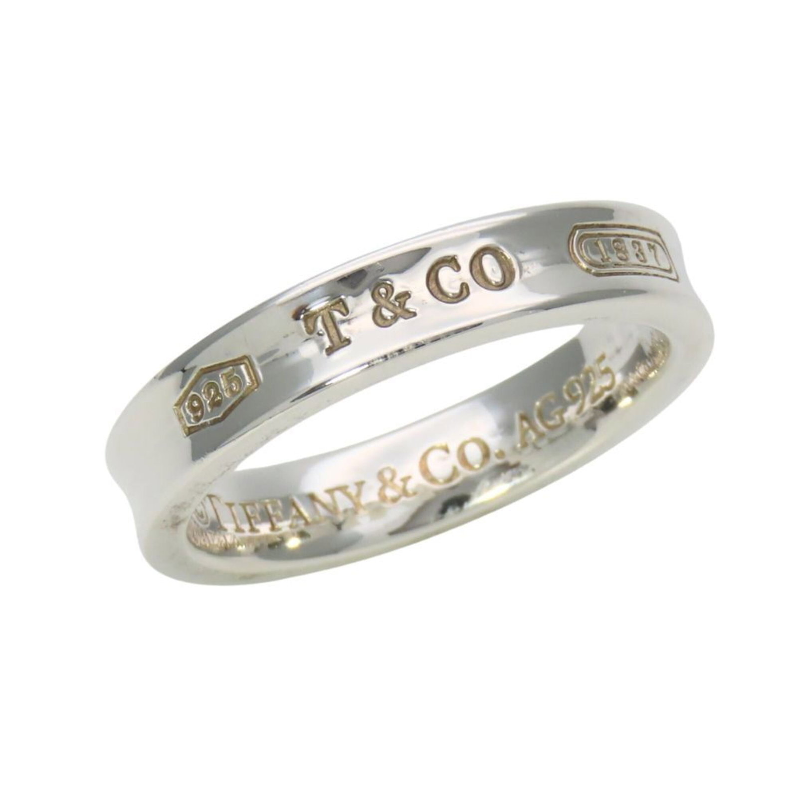 Tiffany Band Ring Silver 925: Tiffany Band Ring Silver 925 Silver 925 Tiffany band ring with a sleek, understated design. This used silver band features some minor scratches and dirt, but overall remains in very good condition. A 