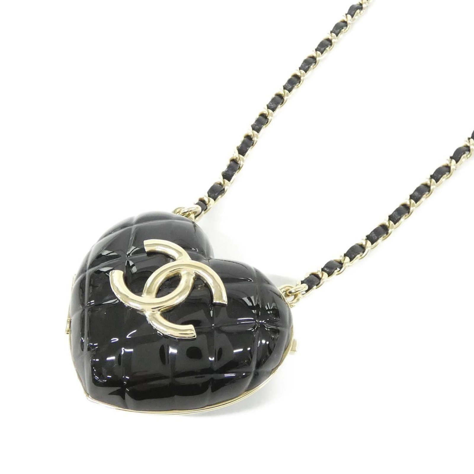Chanel Necklace: Chanel Necklace Black leather Chanel necklace with gold accents, featuring a pendant measuring 60mm x 70mm. The necklace has a classic design and a durable lamb leather construction. Its black color a