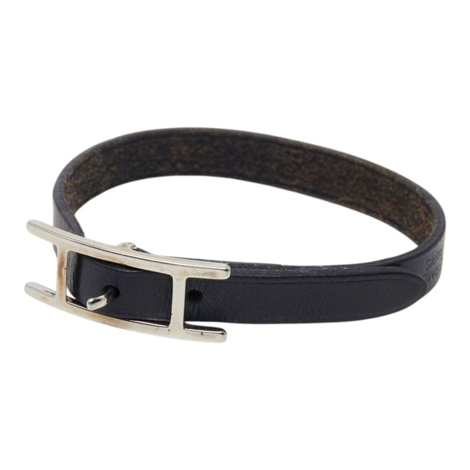 Metal Leather Charm Hermes Bracelet: Metal Leather Charm Hermes Bracelet Black leather and silver metal come together in this classic Hermes charm bracelet, featuring subtle traces of usage and minor scratches. The 17.5cm length provides