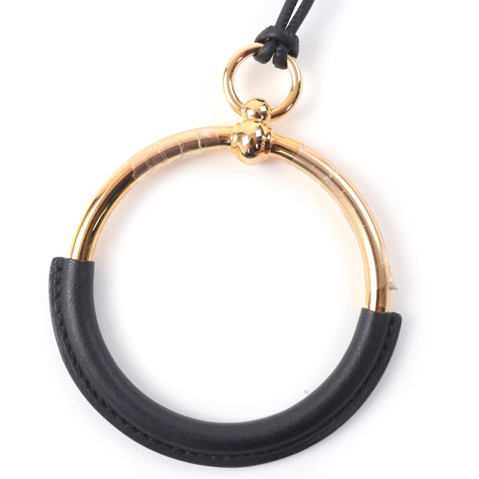 Hermes women's leather necklace grand with gold pendant made in France black dust bag: Hermes women's leather necklace grand with gold pendant made in France black dust bag Black dust bag, made in France, houses the Hermes women's leather necklace grand with gold pendant. This used