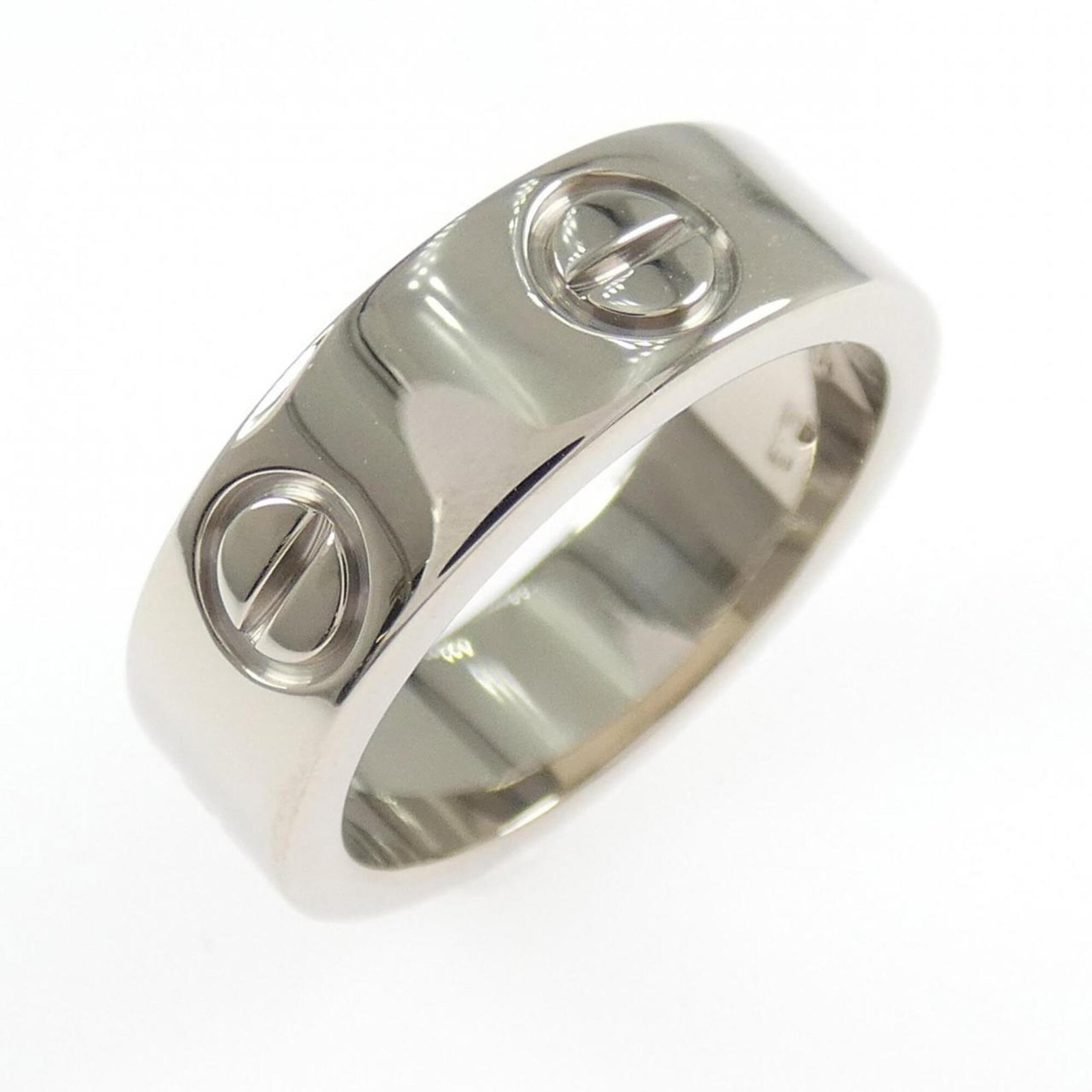 White Gold Cartier Band Ring 18K: White Gold Cartier Band Ring 18K White Gold Cartier Band Ring 18K features an 18k white gold construction, bearing the iconic Cartier brand. The ring's condition shows a few traces of usage, with some