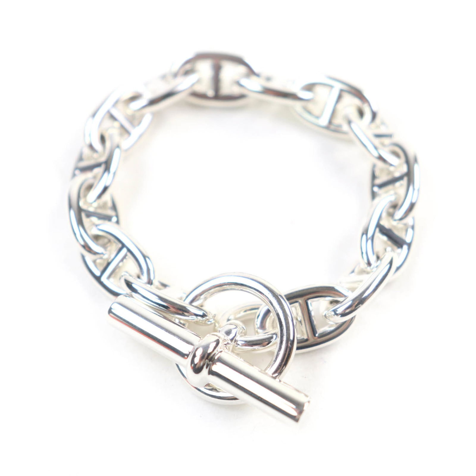 Charm Bracelet by Hermes: Charm Bracelet by Hermes Silver charm bracelet by Hermes, measuring 13.5cm in length and featuring a delicate 1cm width, showcases the brand's signature elegance with its sterling silver925 metal cons