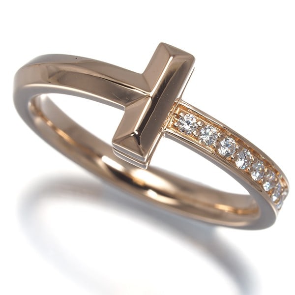 Tiffany Co US5 Ring Diamond 18k Rose Gold: Tiffany Co US5 Ring Diamond 18k Rose Gold Tiffany & Co.'s US5 Ring features a stunning natural diamond set in 18k rose gold. This elegant ring boasts the timeless beauty of Tiffany's iconic design, wi