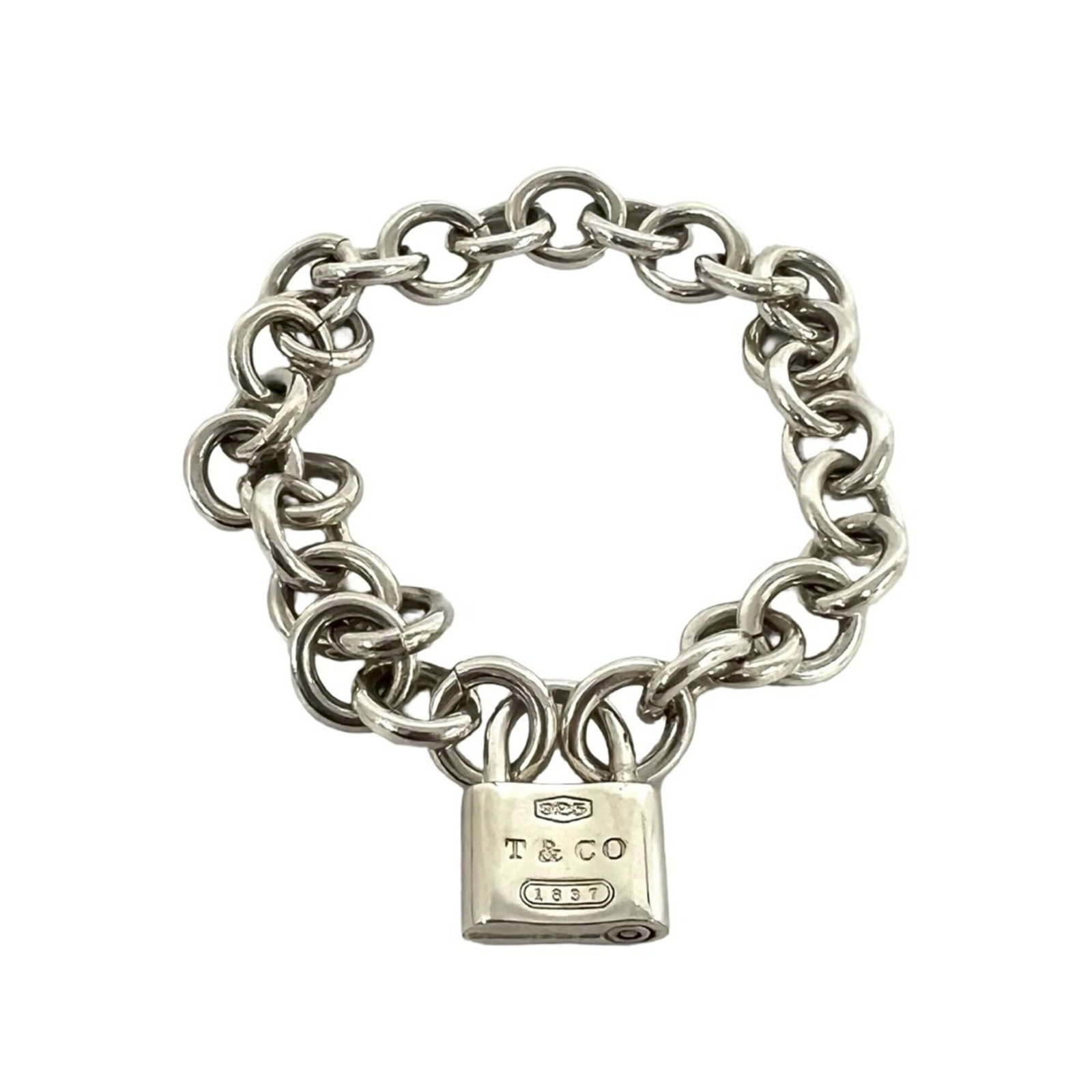 Charm Tiffany Bracelet 925 Silver: Charm Tiffany Bracelet 925 Silver This 925 silver charm bracelet from Tiffany features a classic design with subtle wear, showcasing the gentle patina of age. With its elegant silver tone and 17.5cm l