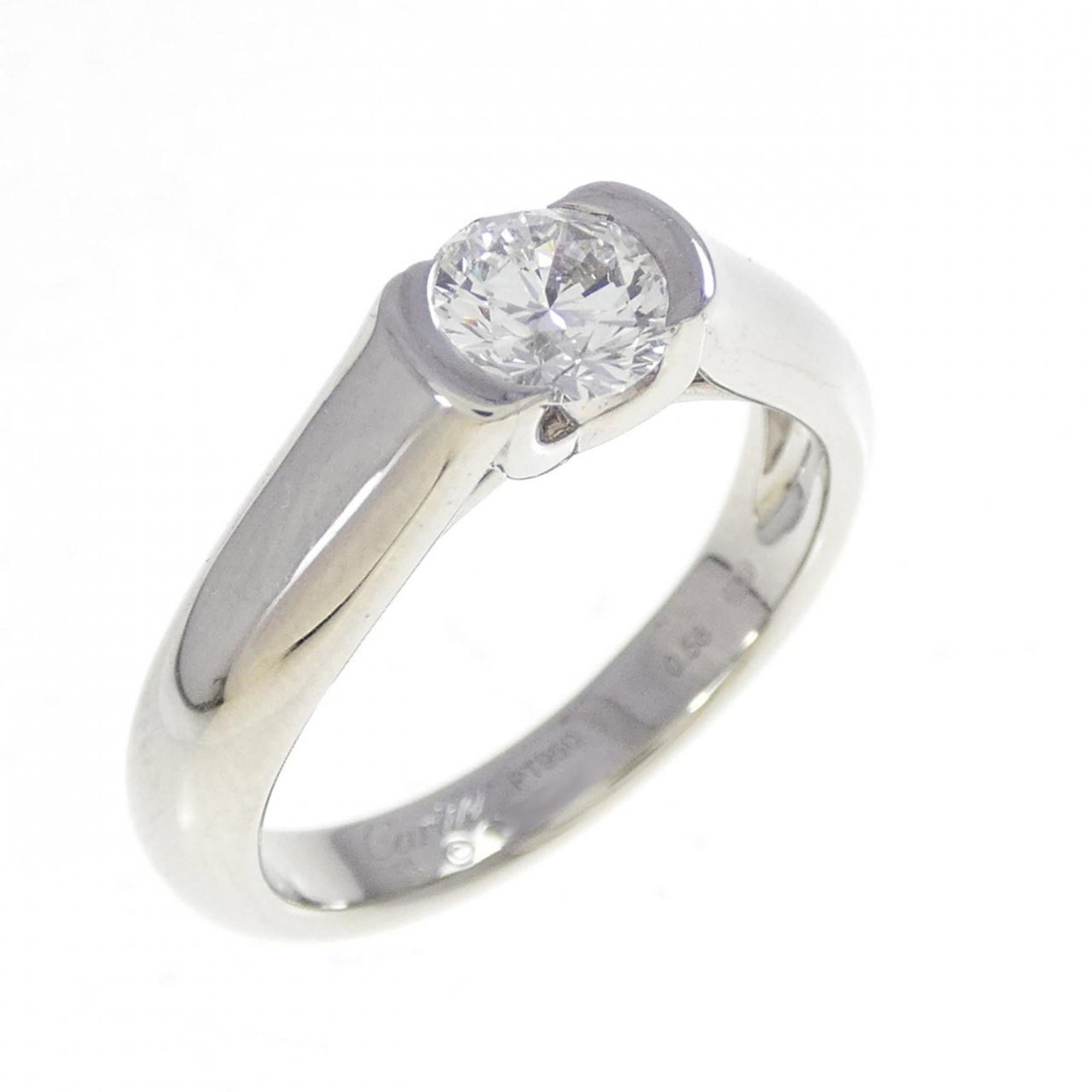 Ring Band by Platinum 950: Ring Band by Platinum 950 Made from platinum 950, this Cartier band ring features a diamond stone and boasts a sleek design. The item shows some signs of usage, with a few scratches and dirt visible,