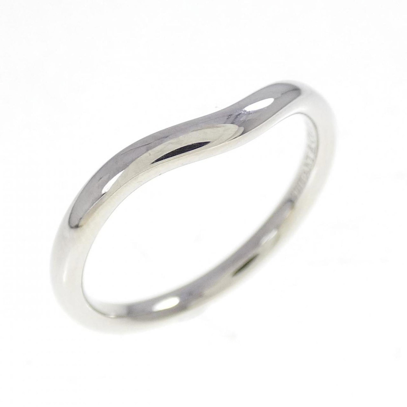 Platinum ring by Tiffany band: Platinum ring by Tiffany band Platinum ring by Tiffany features a band design made from high-quality platinum. The item shows some signs of usage, with a few scratches and minor dirt marks, but remain