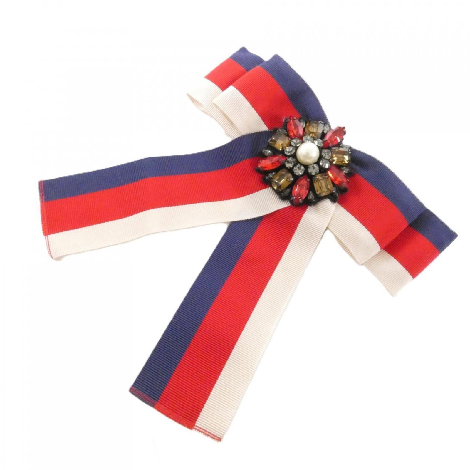 Gucci Brooch: Gucci Brooch Blue, Red Color, White Gucci Brooch measures 14cm x 14cm / 5.51'' x 5.51''. The brooch bears a few traces of usage, with some scratches and dirt visible, yet remains in very good conditio