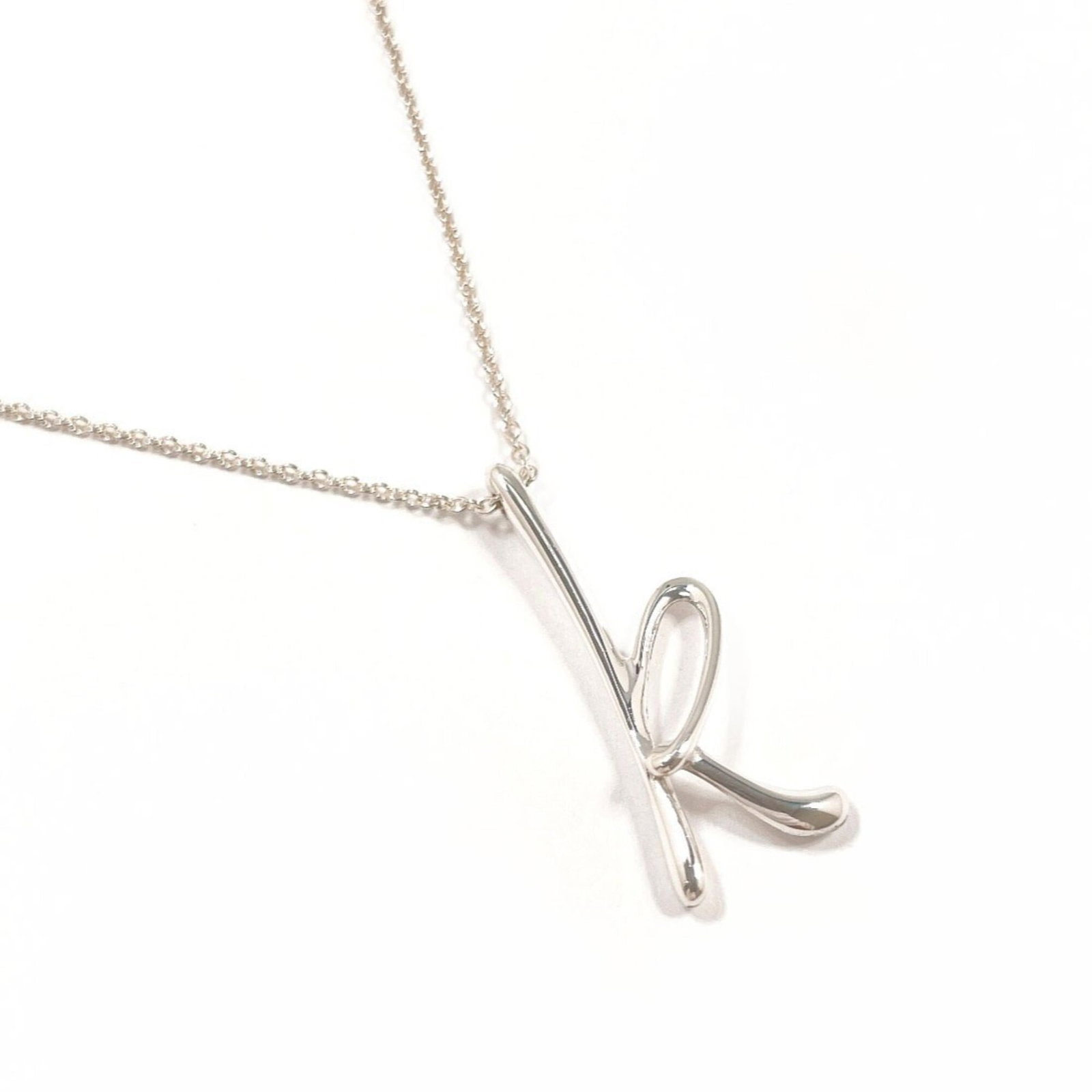 Tiffany&Co. Tiffany Letter K Initial Elsa Peretti Necklace Sterling Silver 925 Women'S: Tiffany&Co. Tiffany Letter K Initial Elsa Peretti Necklace Sterling Silver 925 Women'S Tiffany&Co.'s iconic Tiffany Letter K Initial Elsa Peretti necklace shines in sterling silver, its sleek design