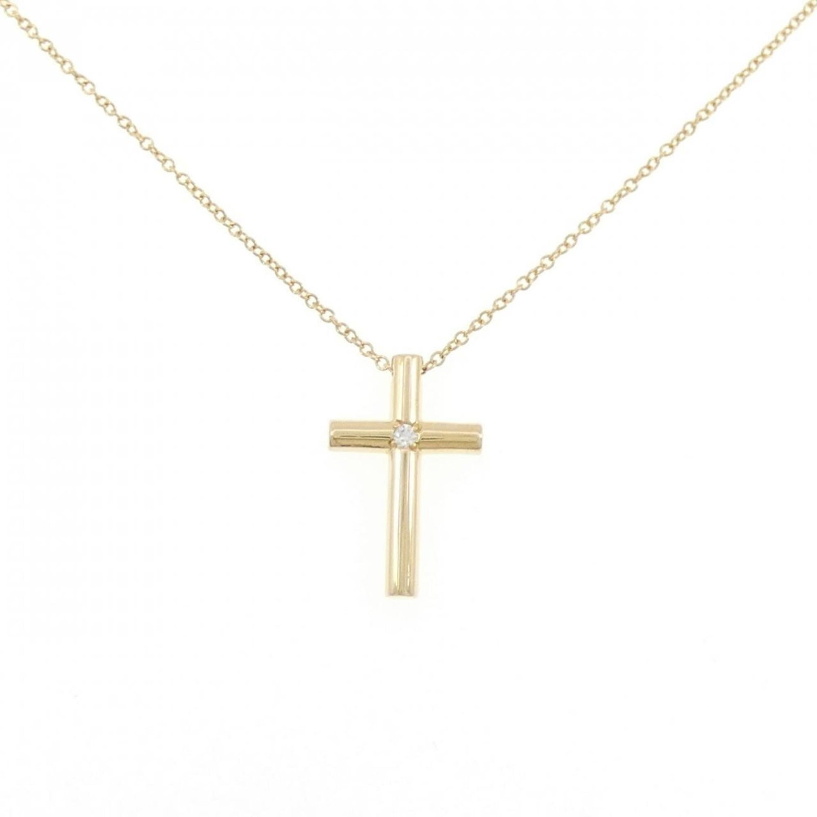 Cross Necklace by Tiffany: Cross Necklace by Tiffany Yellow gold (18K) Tiffany necklace featuring a diamond pendant, weighing 3.4g and measuring 17.9mm x 11.3mm, set in a 40 cm chain with a few traces of usage visible. The