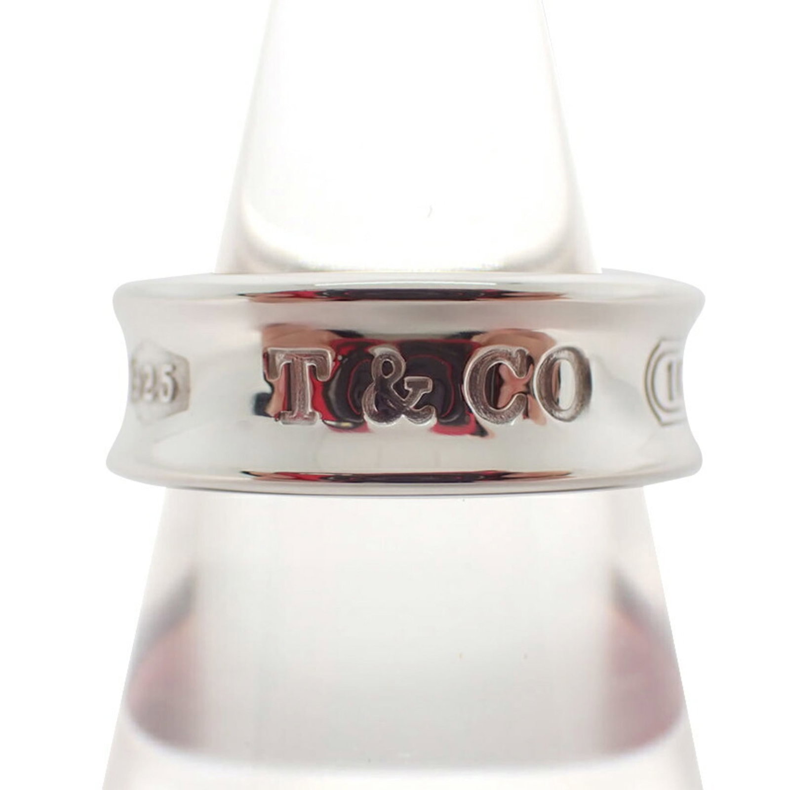 Sterling Silver Ring Tiffany Band: Sterling Silver Ring Tiffany Band Sterling silver ring from Tiffany, featuring a classic band design. The 52mm band size accommodates a US size 6.5 finger, with some minor scratches and dirt visible