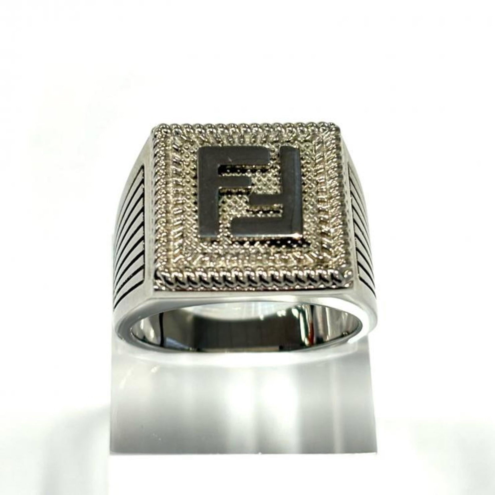 Fendi Band Ring: Fendi Band Ring Silver Fendi band ring with traces of usage, scratches and dirt. This used band ring is in good condition despite showing signs of wear. The silver finish remains intact, showcasing th