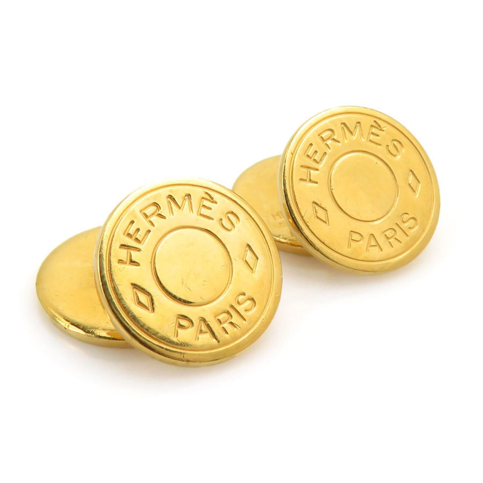 Metal cufflinks by Hermes: Metal cufflinks by Hermes Gold metal cufflinks by Hermes, measuring 15.00mm x 15.00mm x 15.00mm, feature a subtle design that showcases the brand's signature style. With traces of usage and minor scra