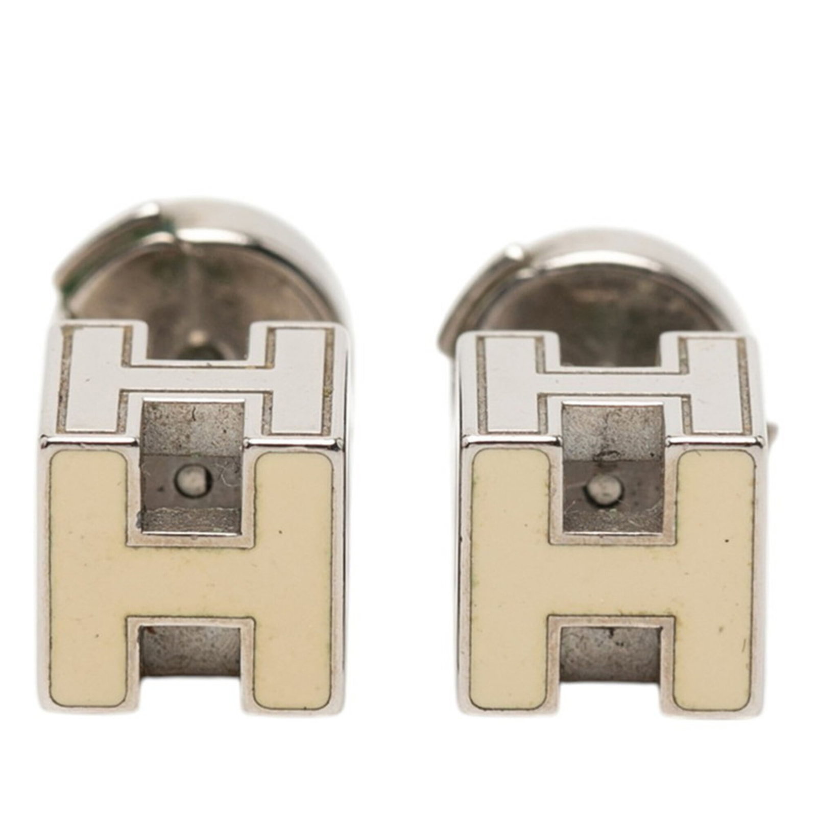Stud Earrings Metal Enamel Hermes: Stud Earrings Metal Enamel Hermes Stud earrings with a unique metal enamel design from the renowned brand Hermes. The beige and silver studs showcase intricate details, adding a touch of elegance to a