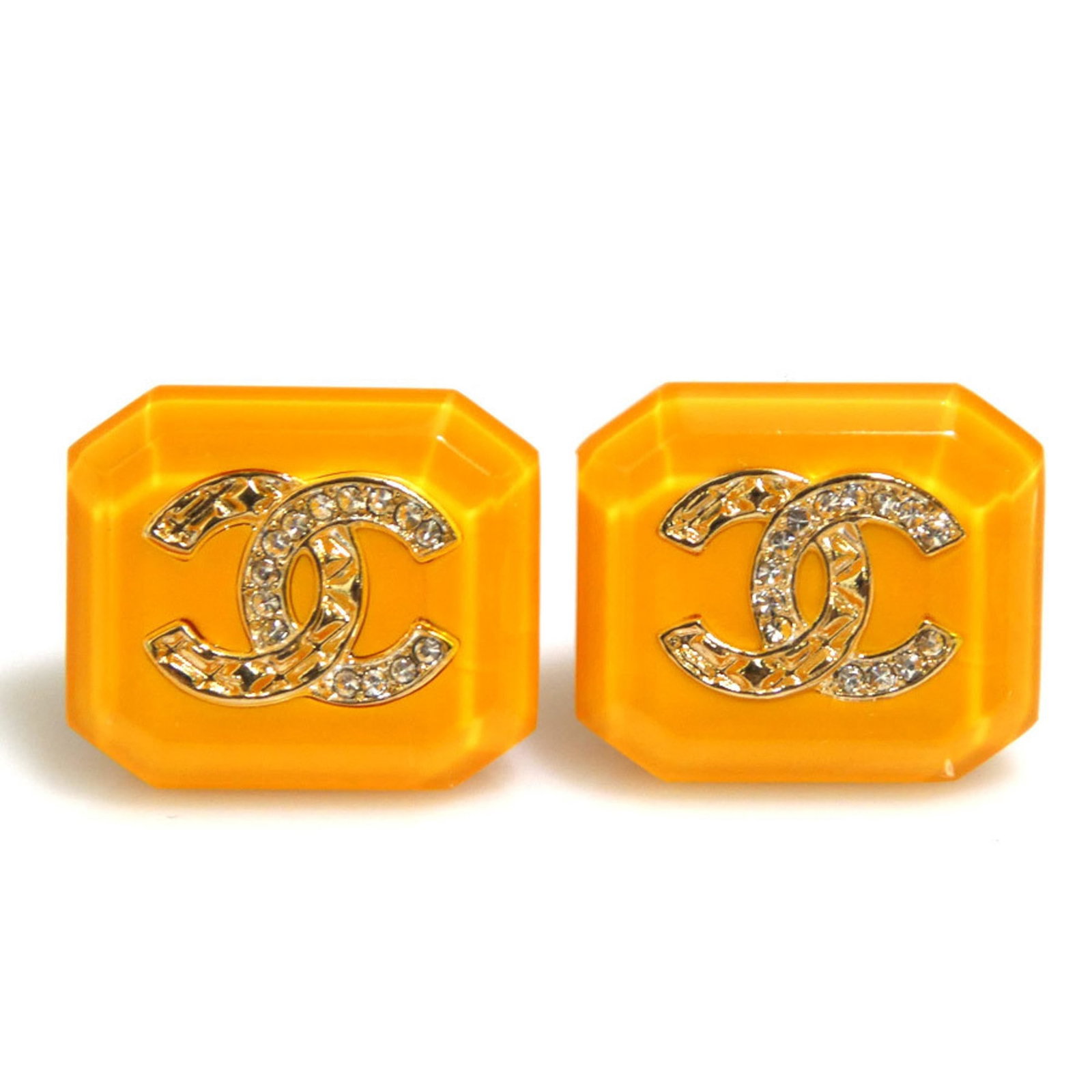 Metal resin stud earrings by Chanel: Metal resin stud earrings by Chanel Metal resin stud earrings by Chanel, featuring a gold and yellow color, are available in good condition with traces of usage. The earrings measure 17.00mm x 20.00mm