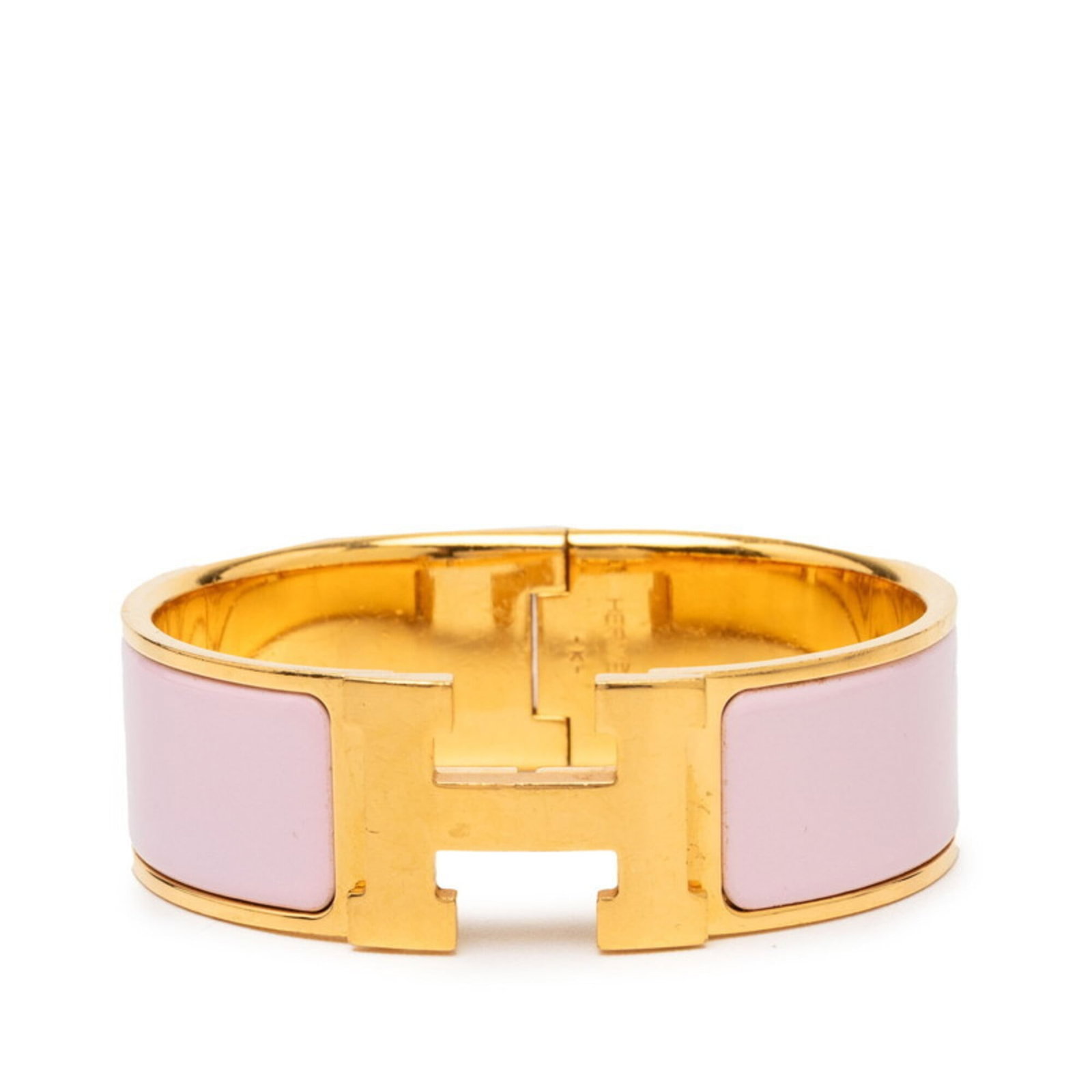 Hermes Enamel Bangle: Hermes Enamel Bangle Gold and pink enamel come together in this iconic Hermes bangle, measuring 16.5cm in length. With its classic design and subtle wear, this piece bears the signature of the renowne