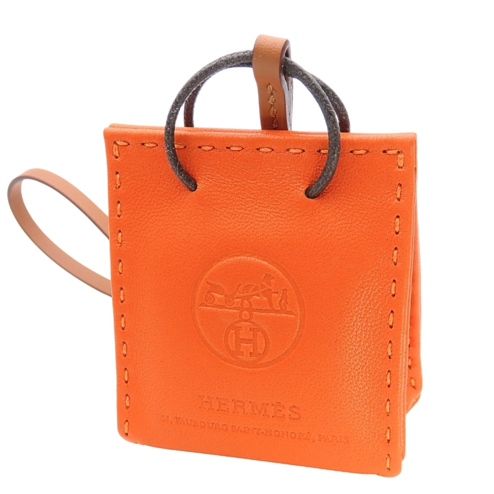 Hermes Handbag Charm Agneau Milo: Hermes Handbag Charm Agneau Milo Agneau Milo charm from the iconic Hermes handbag collection, featuring a vibrant orange hue that adds a pop of color to any accessory. This small yet striking charm