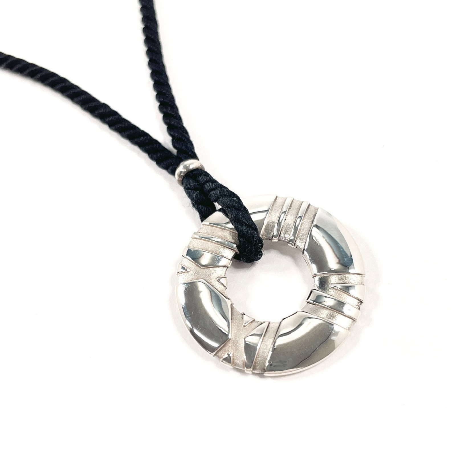 Tiffany Atlas Circle Silver Silk Necklace 925 For Women: Tiffany Atlas Circle Silver Silk Necklace 925 For Women Silver necklace with black and silver details, featuring a 27mm x 27mm pendant. Made from high-quality 925 sterling silver, this circle-shaped d