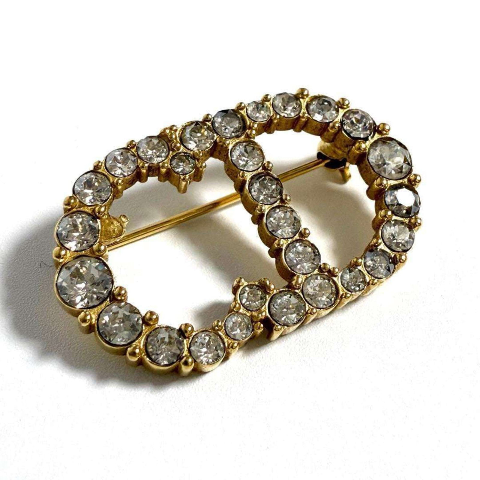 Dior Brooch Metal Christian Rhinestone: Dior Brooch Metal Christian Rhinestone Metallic accents and rhinestones come together in Christian Dior's elegant brooch, adding a touch of sophistication to any outfit. With its striking design and