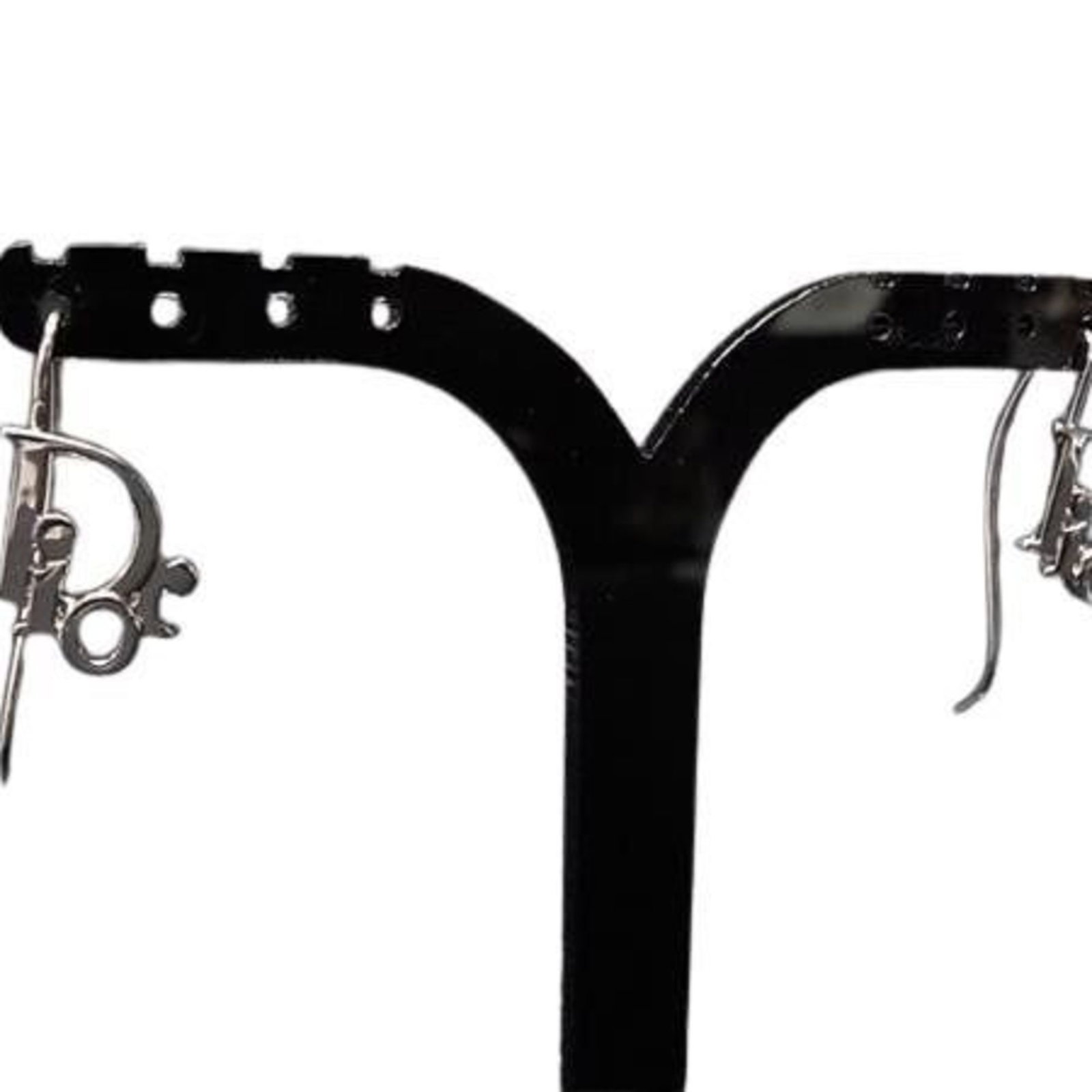 Dior Christian Metal Drop Earrings: Dior Christian Metal Drop Earrings Silver Dior Christian Metal Drop Earrings, featuring a sleek and modern design. With their striking silver metal construction, these drop earrings add a touch of sop