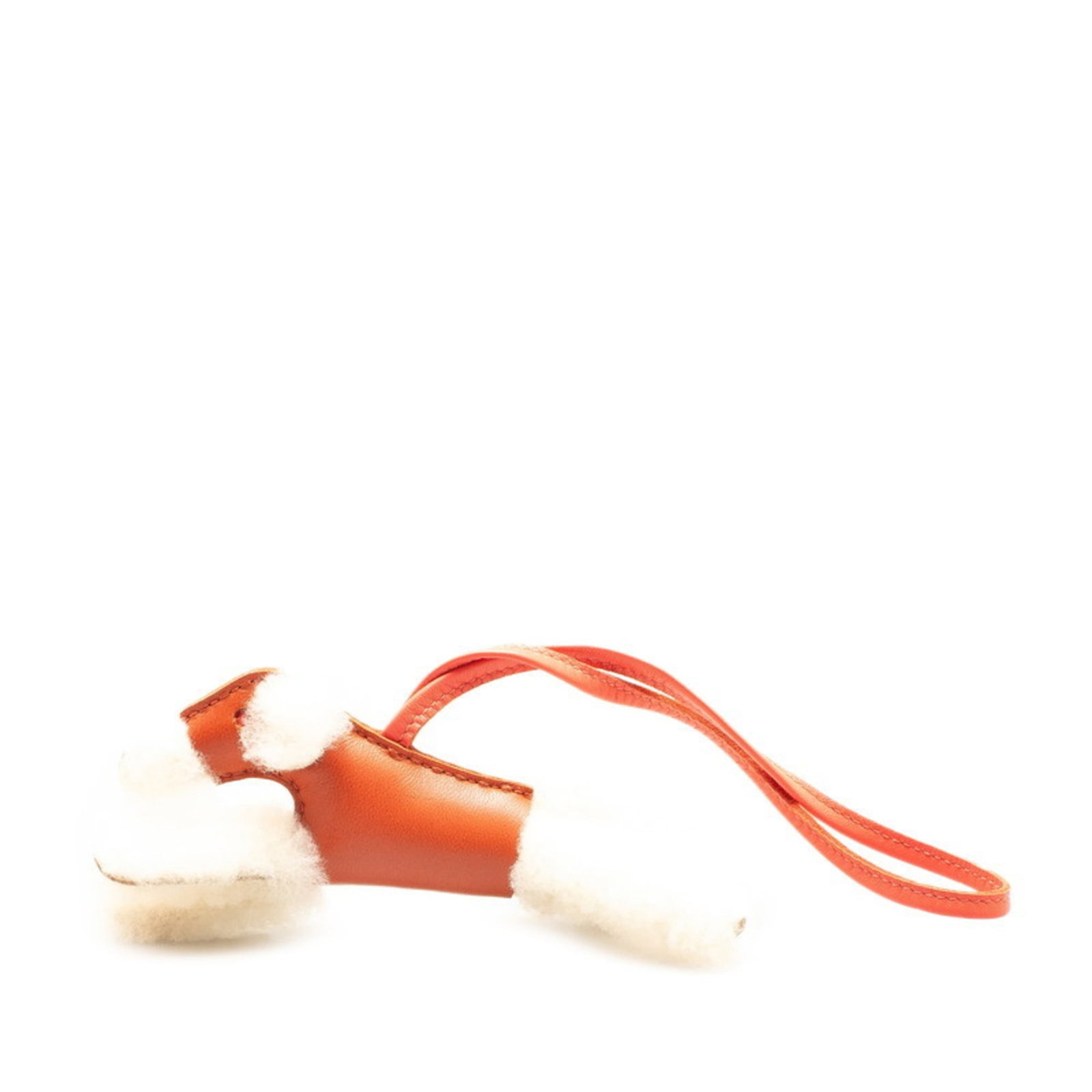 Hermes handbag leather agneau charm: Hermes handbag leather agneau charm Agneau leather charm from Hermes features intricate Mouton design in ivory and red hues, adding a touch of elegance to any outfit. The charm measures 54.70mm x