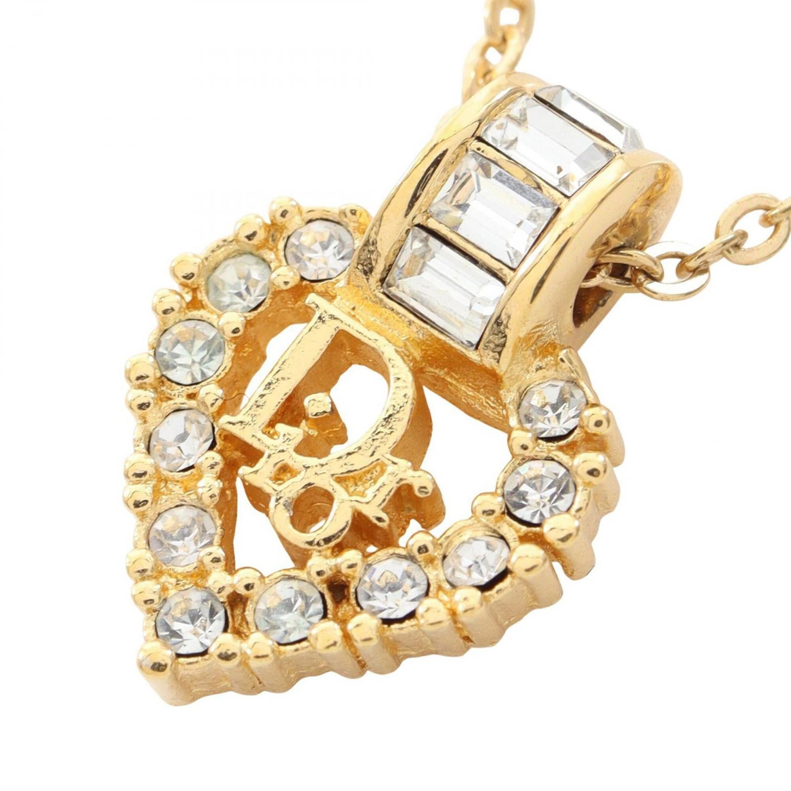 Christian Dior heart necklace gold plated rhinestone women's tone clear: Christian Dior heart necklace gold plated rhinestone women's tone clear Gold plated rhinestone heart pendant from Christian Dior adds a touch of elegance to any outfit. The clear, gold-toned necklace