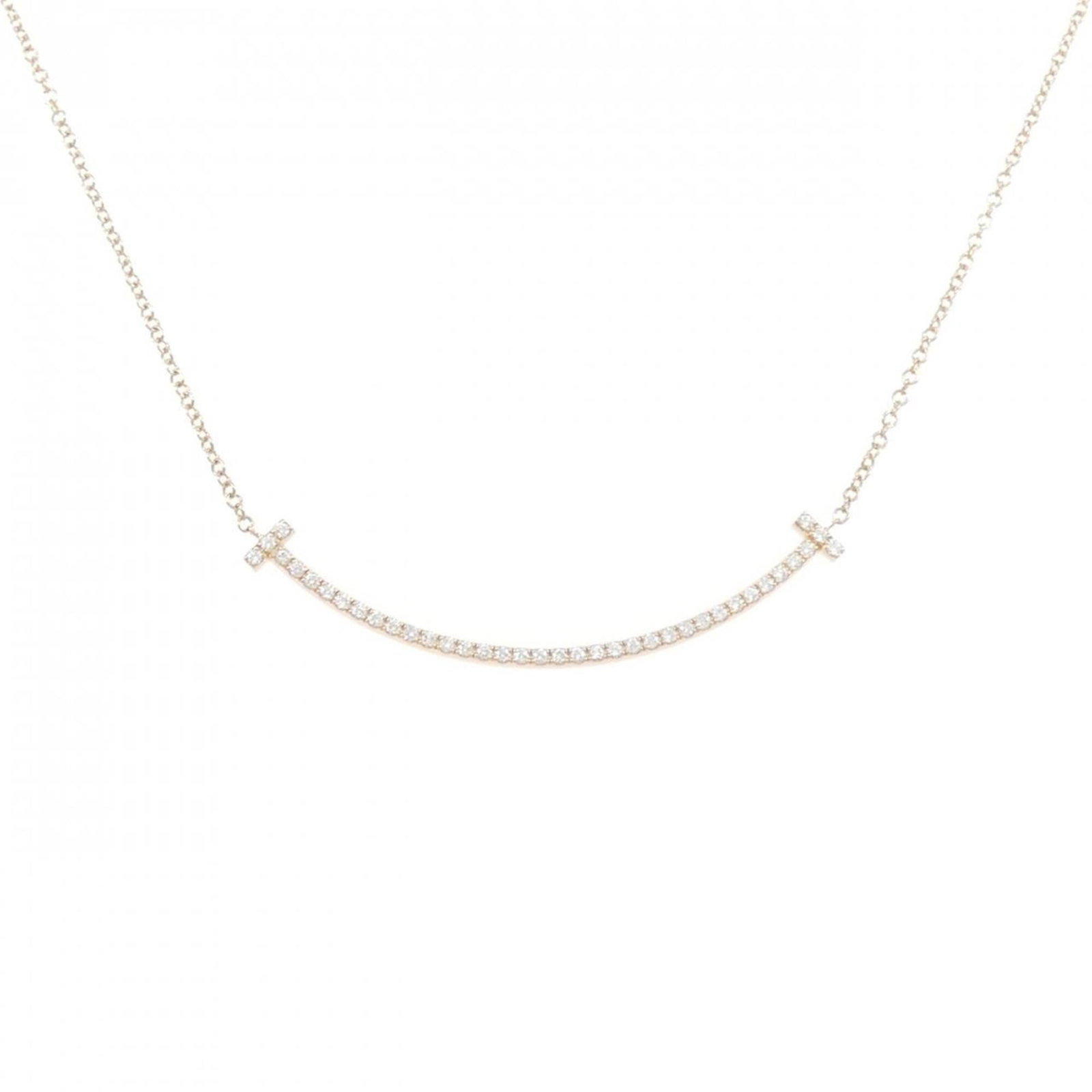 Smile of Tiffany T Necklace Small: Smile of Tiffany T Necklace Small Pink gold (18K) pendant featuring a small diamond, suspended from a chain with a 41 cm circumference. The necklace bears a few traces of usage and minor scratches/dir