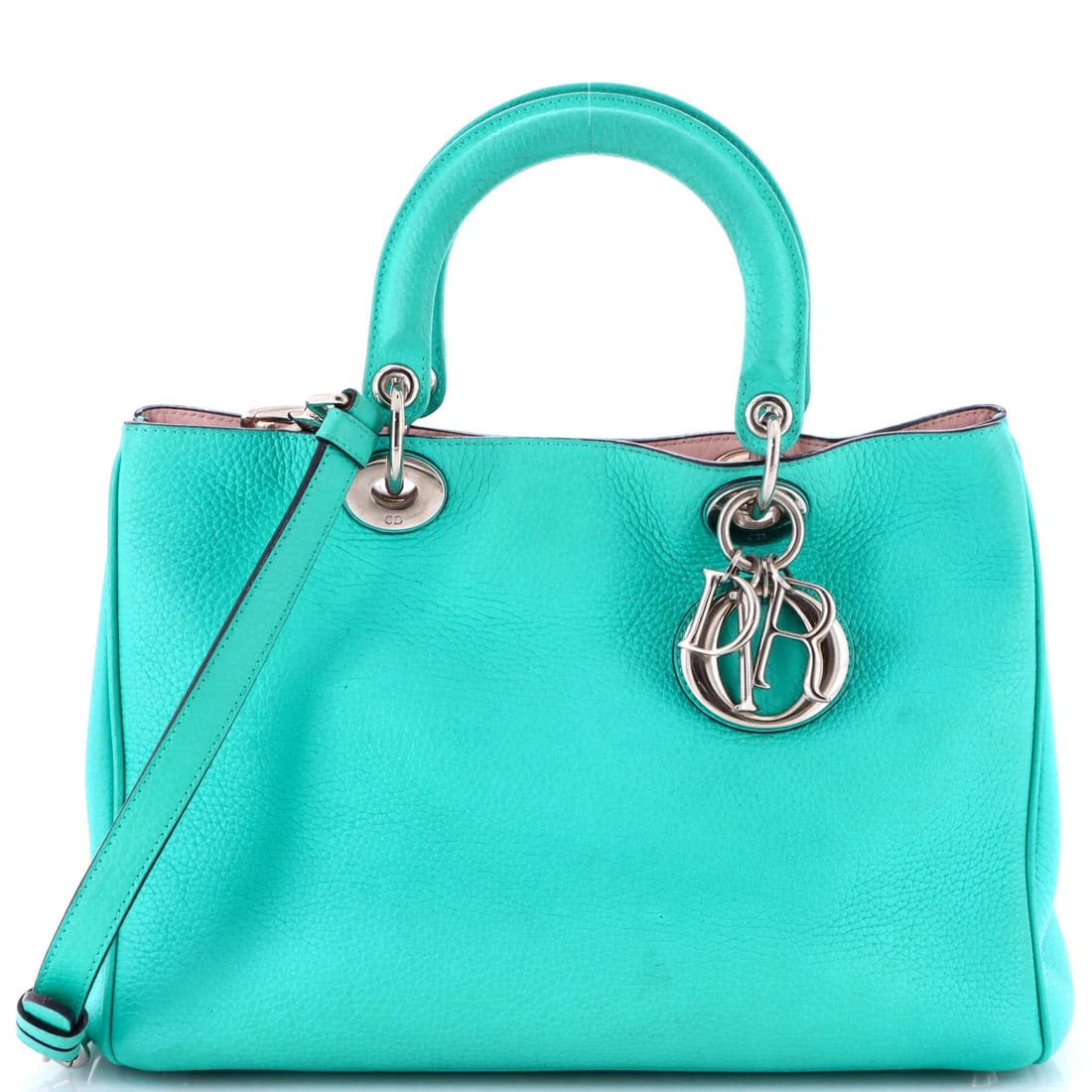 Christian Dior Tote Medium Pebbled Leather: Christian Dior Tote Medium Pebbled Leather The Christian Dior Tote Medium Pebbled Leather in blue features a classic design with a medium size and pebbled leather exterior. This stylish tote boasts