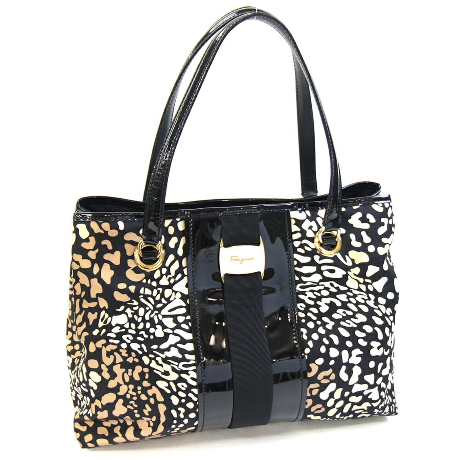 Nylon leather tote bag by Salvatore Ferragamo: Nylon leather tote bag by Salvatore Ferragamo Nylon leather tote bag by Salvatore Ferragamo features a unique blend of materials, combining nylon and enamel leather for a distinctive look. With its cl