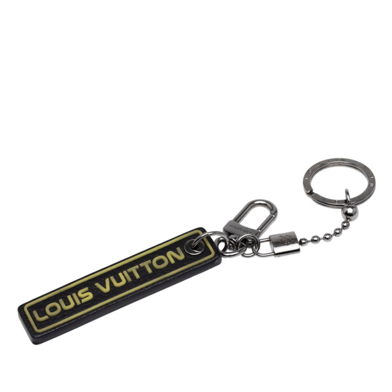 Louis Vuitton Keyring: Louis Vuitton Keyring This Louis Vuitton keyring boasts the iconic monogram pattern in black and yellow, adding a touch of luxury to any outfit. With its sleek design and compact size, it's perfect