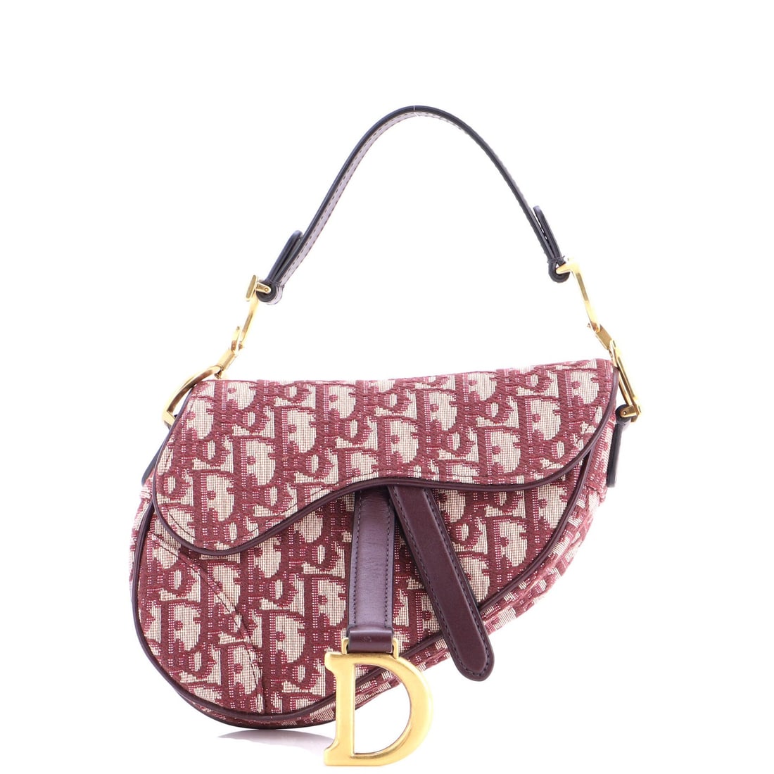 Christian Dior Saddle Handbag Oblique Canvas Mini: Christian Dior Saddle Handbag Oblique Canvas Mini The Christian Dior Saddle Handbag Oblique Canvas Mini boasts a striking red exterior, crafted from plain canvas and adorned with aged gold hardware. M