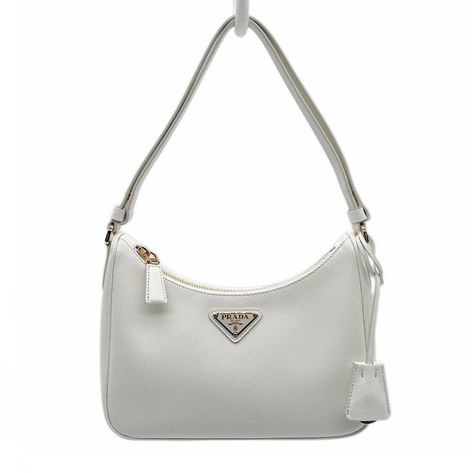 Prada Handbag Leather: Prada Handbag Leather Saffiano leather handbag with white color, measuring 16.5cm x 22cm x 6.5cm, features a sturdy handle length of 44cm. The bag has undergone some usage, showing a few traces of scr