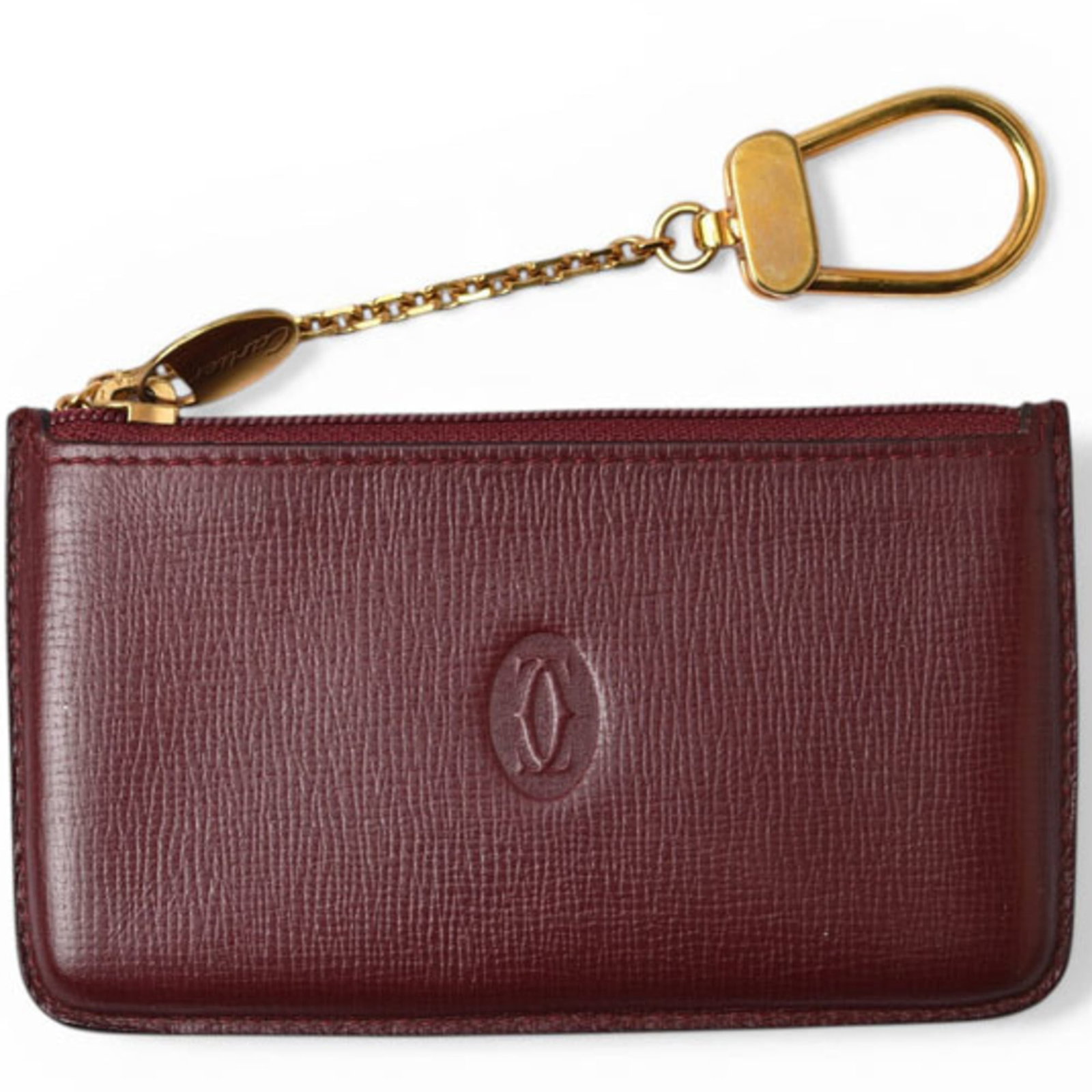 Coin Case Leather Purse Cartier: Coin Case Leather Purse Cartier Bordeaux leather coin case from Cartier, featuring a classic design with a zipper closure. This used item has some traces of usage and minor scratches, but remains in