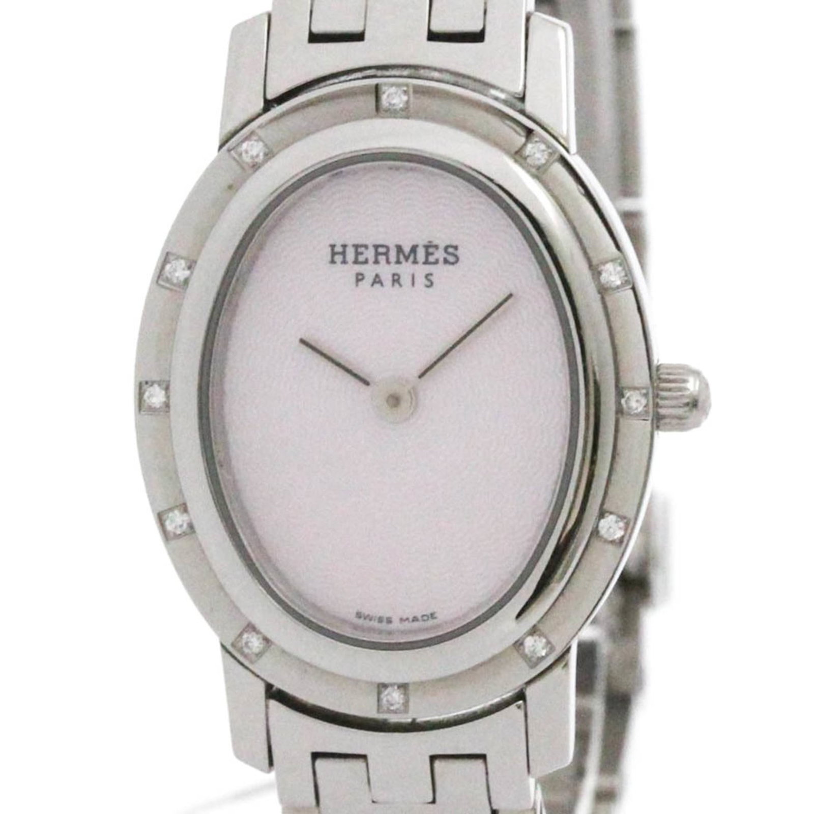 Hermes Wristwatch: Hermes Wristwatch Stainless steel case and band, pink shell dial, and classic dress watch style make this Hermes wristwatch a timeless piece. With its 22mm diameter and used condition featuring some s