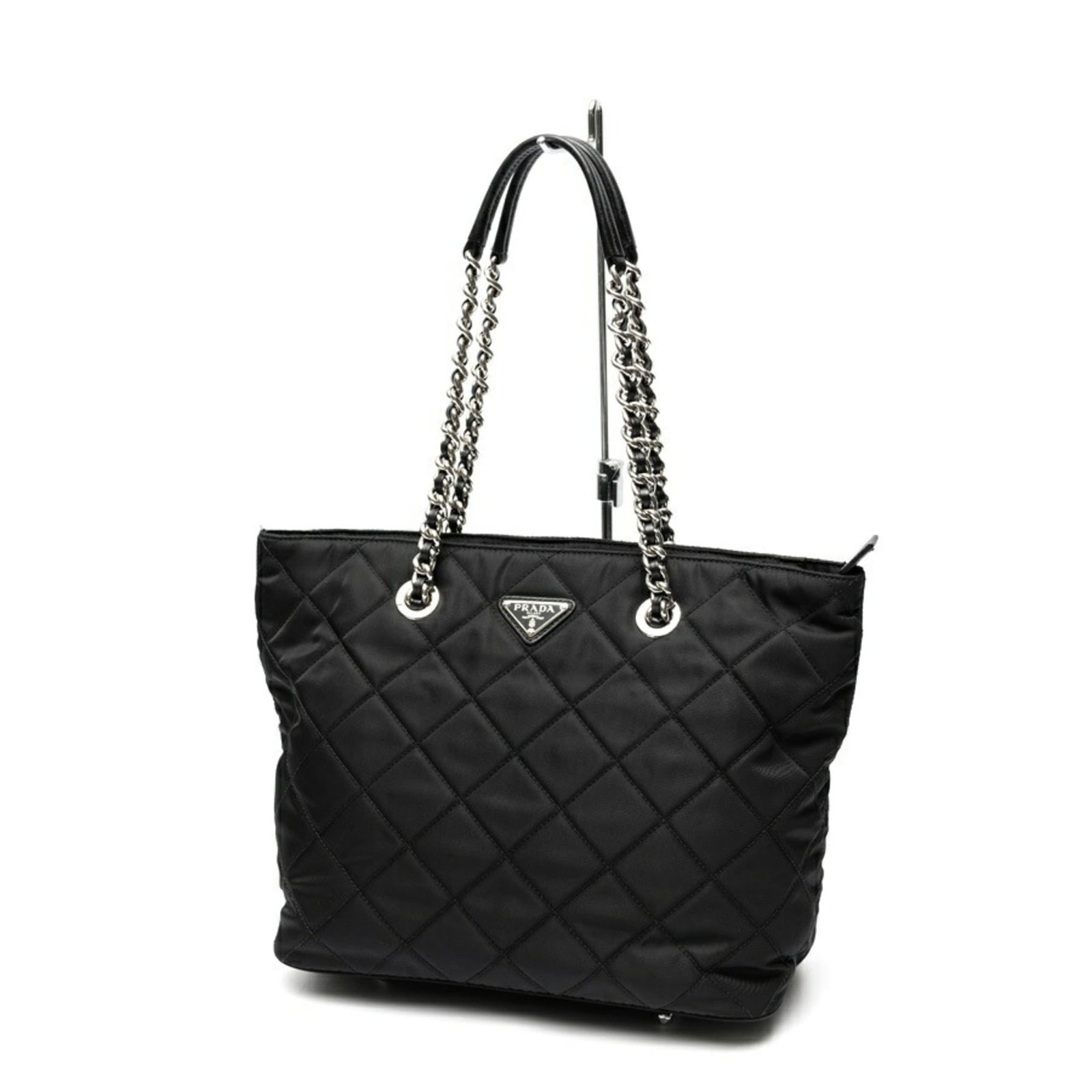 Nylon Prada Tote: Nylon Prada Tote Black nylon Prada tote with a classic design, measuring 25cm x 29.5cm x 13.5cm. This used tote bag has some scratches and dirt but remains in very good condition, bearing the brand's