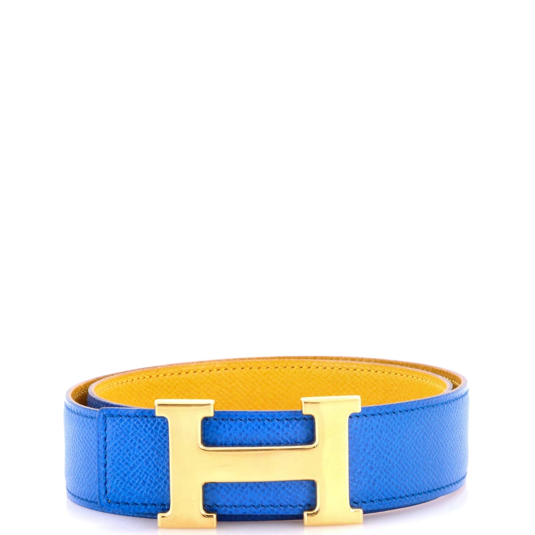 Constance Leather Belt Medium Hermes Reversible: Constance Leather Belt Medium Hermes Reversible The Constance Reversible Belt by Hermes features a striking blue exterior and yellow interior, with gold hardware adding a touch of elegance. Made from
