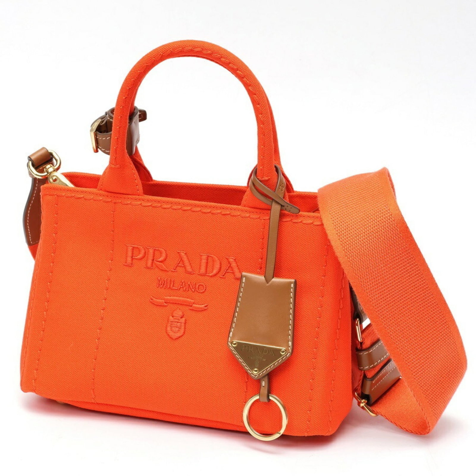 Cotton canvas tote bag by Prada: Cotton canvas tote bag by Prada Prada's cotton canvas tote bag boasts vibrant orange hues, adding a pop of color to any outfit. Measuring 15cm x 22cm x 13cm, it offers ample space for daily essentials
