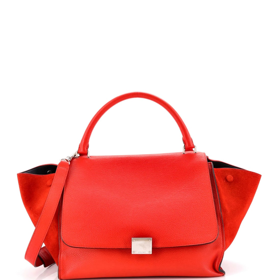 Celine Trapeze bag medium leather: Celine Trapeze bag medium leather The Celine Trapeze bag medium leather features a striking red exterior with heavy edge wear, scuffs, and creases that add to its unique character. This stylish top