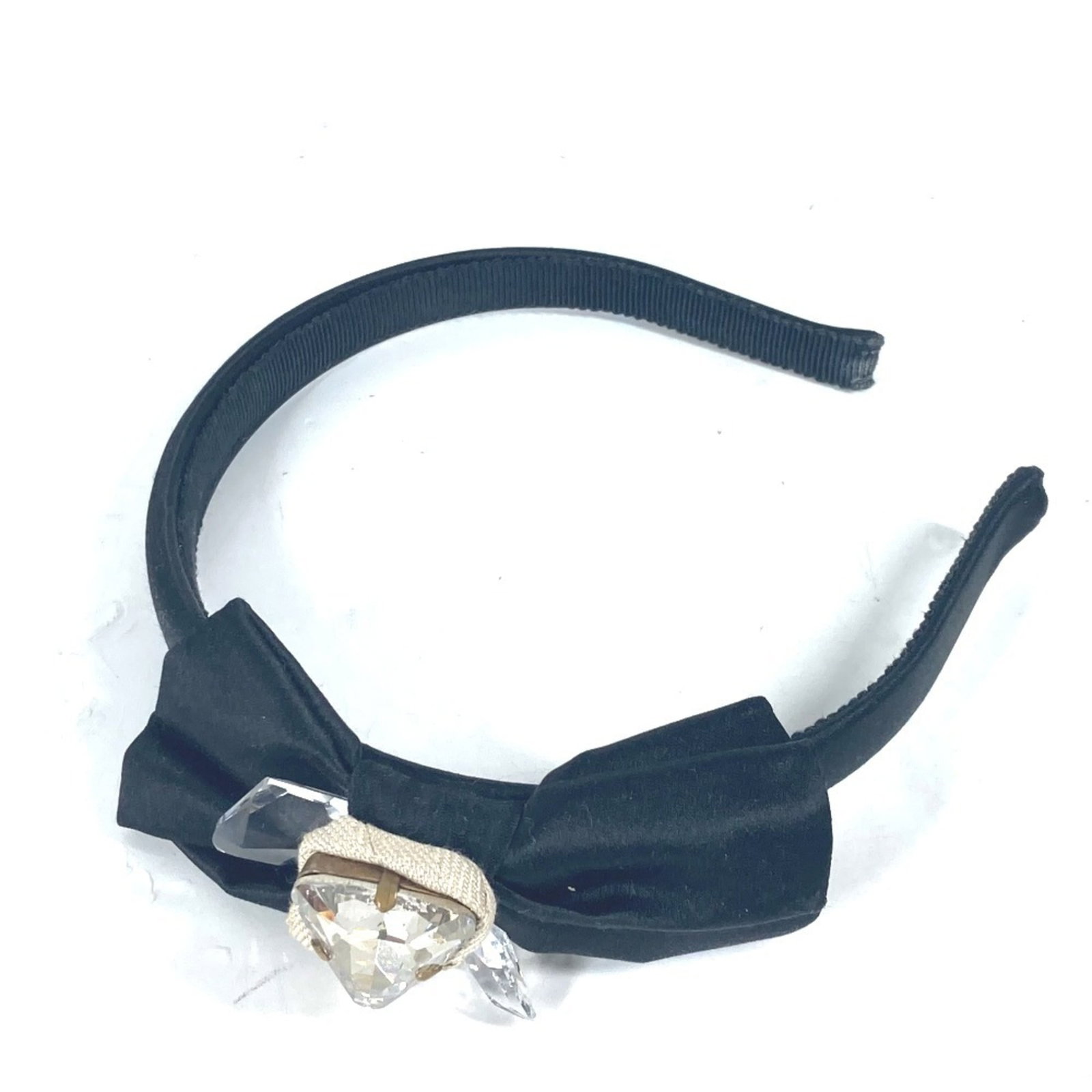 Alice Miu Satin Band: Alice Miu Satin Band The Alice Miu Satin Band is a sleek and sophisticated accessory featuring crystal accents in black satin. With its elegant design, it adds a touch of glamour to any outfit. A few