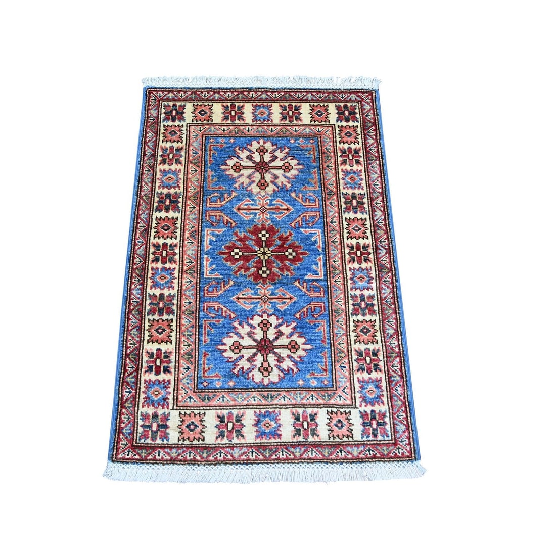 2'x3' Blue Afghan Super Kazak Hand Knotted Pure Wool Sample Mat Rug: 2'x3' Blue Afghan Super Kazak Hand Knotted Pure Wool Sample Mat Rug The Blue Afghan Super Kazak Hand Knotted Pure Wool Sample Mat Rug boasts an all-over regional design in a vibrant blue field,