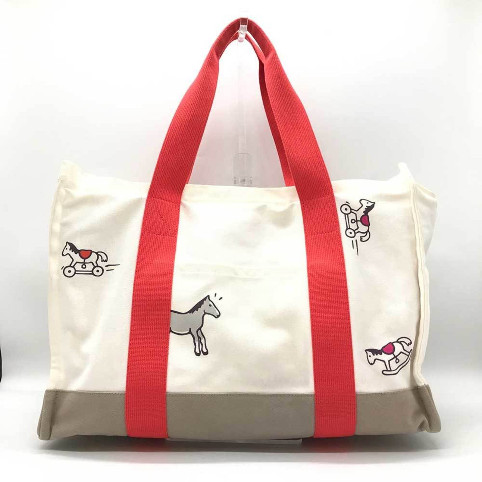Canvas tote bag by Hermes: Canvas tote bag by Hermes Canvas tote bag by Hermes, featuring an ivory and red color combination. Made from high-quality canvas material, this stylish tote measures 29cm x 42cm x 20cm. With a few