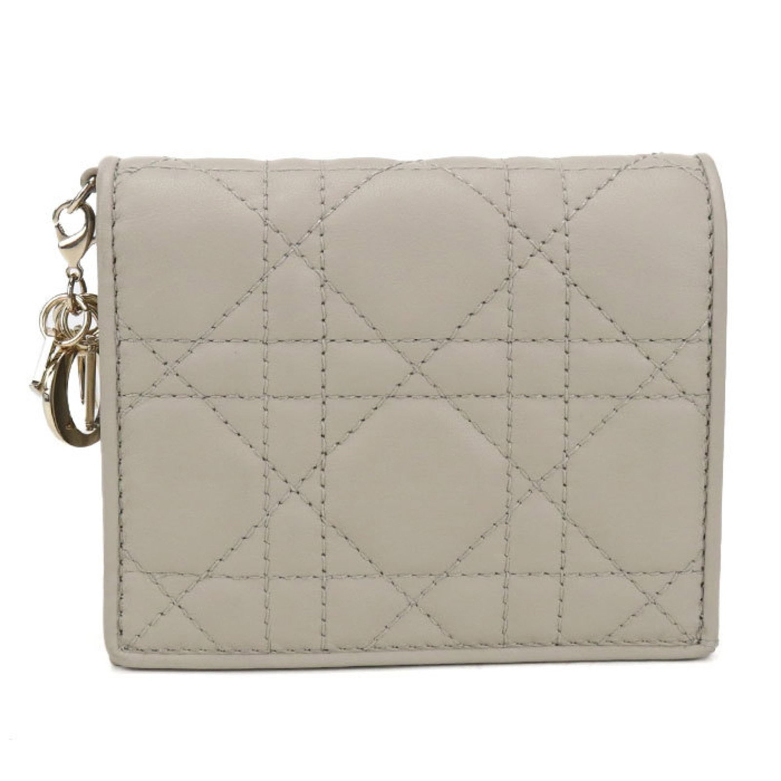 Christian Dior Bi Fold Leather Wallet: Christian Dior Bi Fold Leather Wallet The Christian Dior Bi Fold Leather Wallet boasts a classic design with a timeless beige lambskin exterior, perfectly complemented by an inner pocket and bill