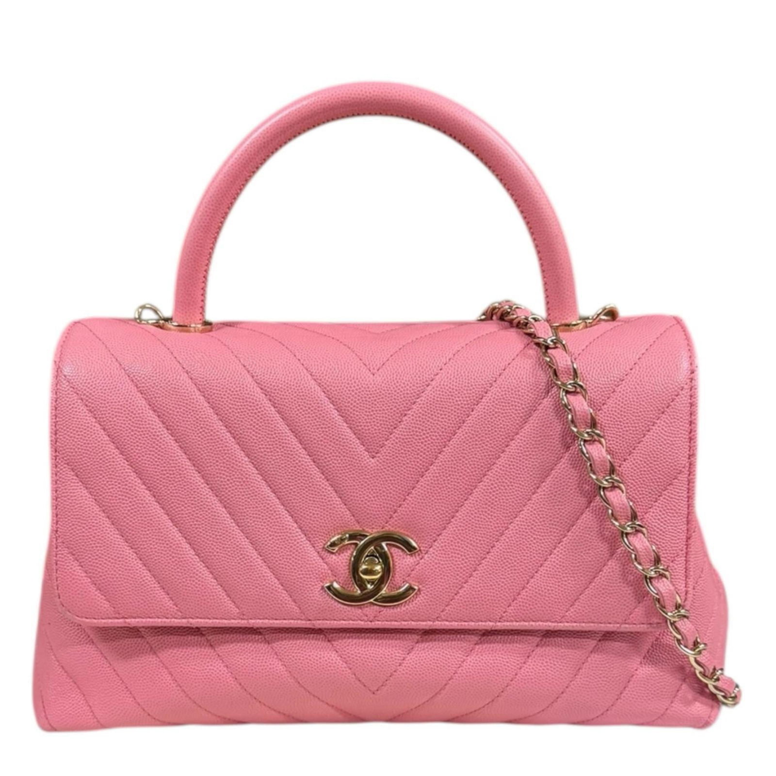 Calfskin shoulder bag by Chanel: Calfskin shoulder bag by Chanel Pink Grained Calfskin Shoulder Bag by Chanel. This pre-owned shoulder bag features turn lock closure, two zipper pockets and an open pocket for added storage, all on a