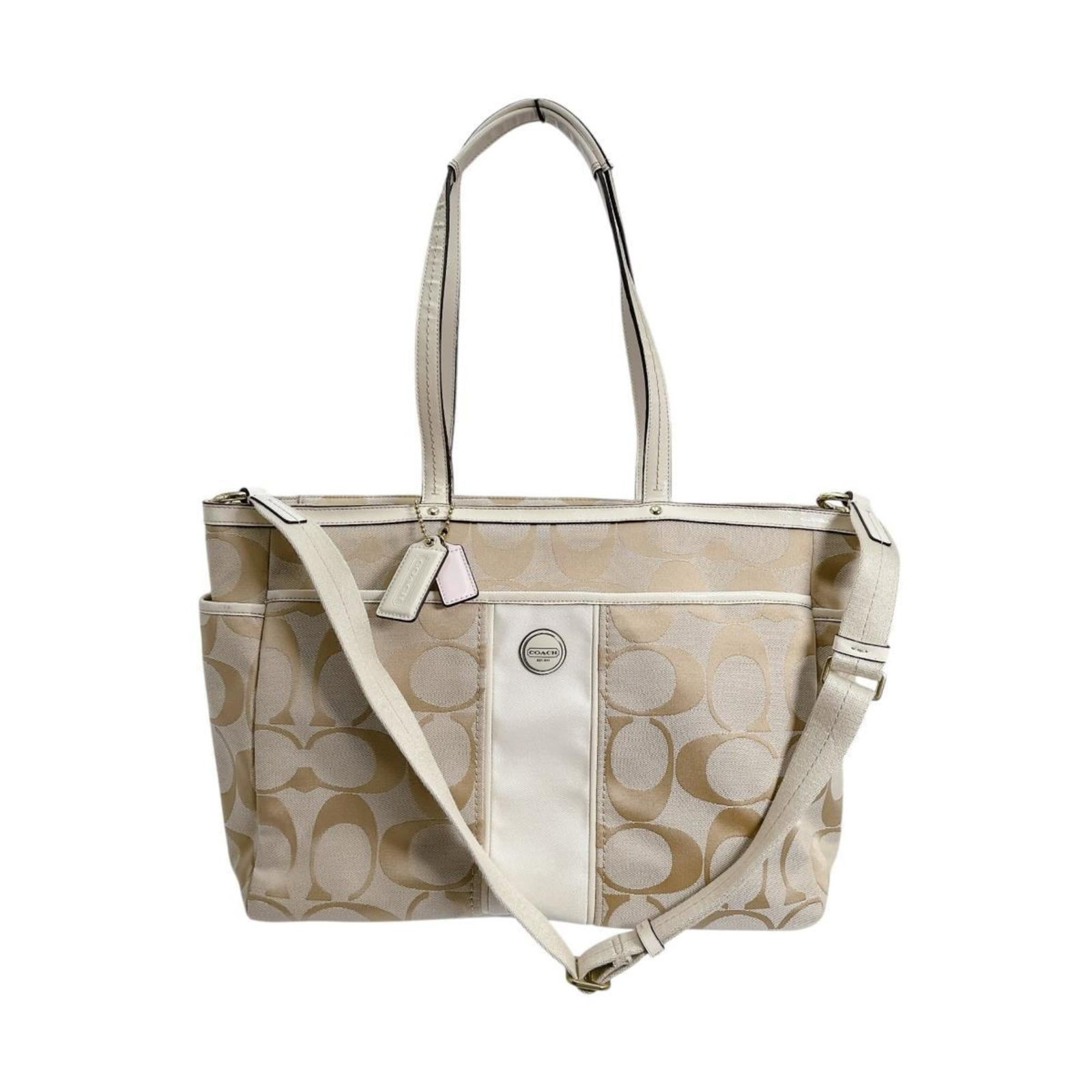 Canvas tote bag handbag coach: Canvas tote bag handbag coach Canvas tote bag from Coach, featuring a classic beige color and sturdy canvas material. The bag boasts a timeless design with a zipper closure and a spacious interior