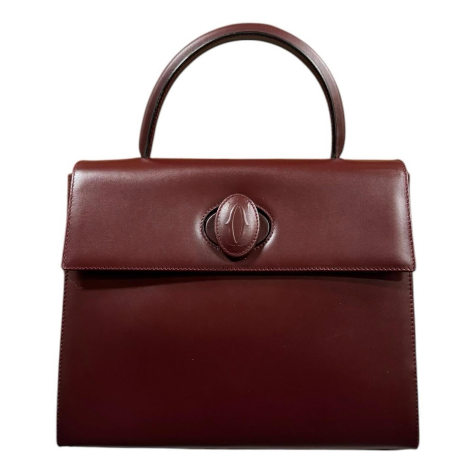 Handbag Leather by Cartier: Handbag Leather by Cartier Bordeaux and Red leather handbag by Cartier in excellent used condition, with some minor scratches and dirt visible. The bag's classic design and premium materials make it