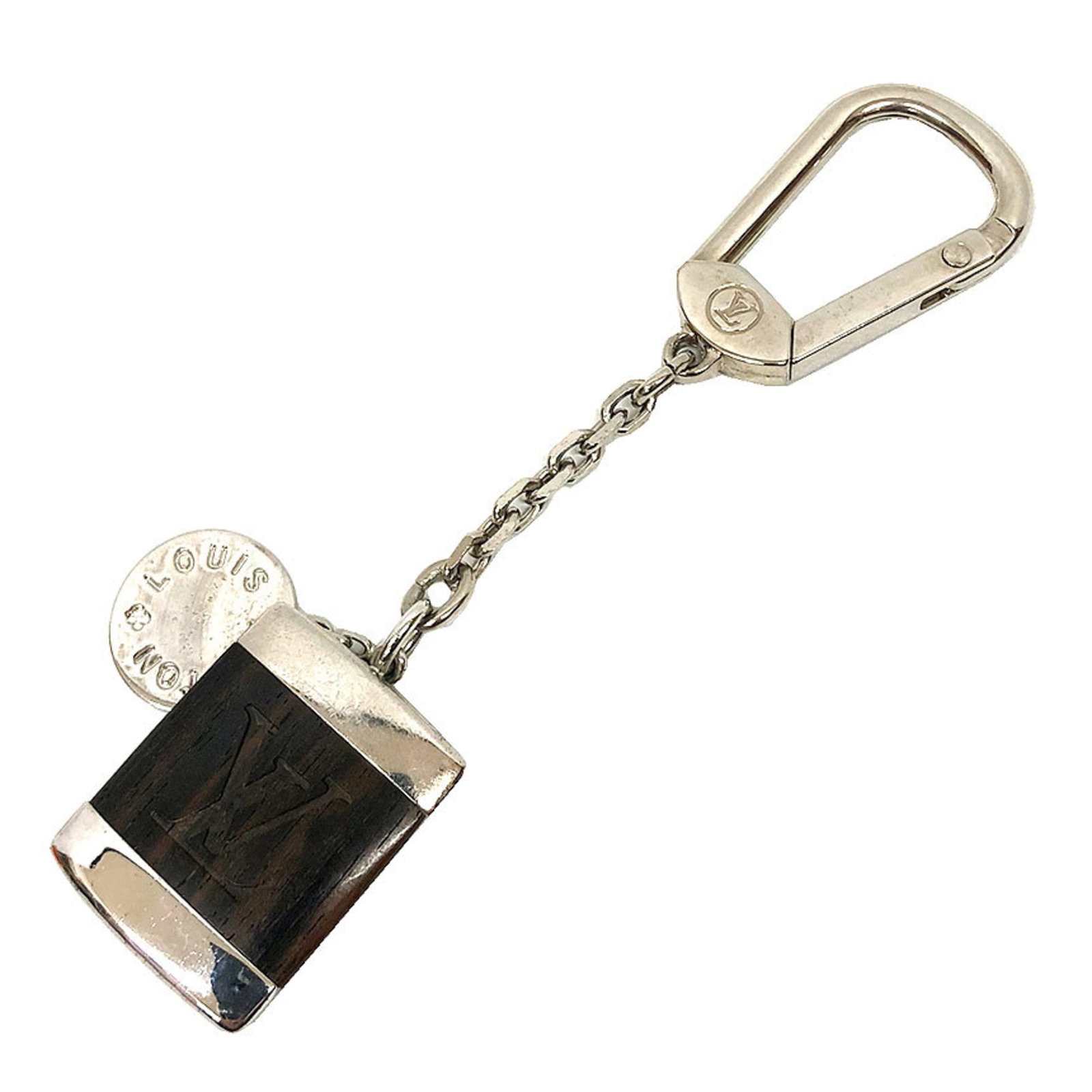 Louis Vuitton Keyring Metal Wood: Louis Vuitton Keyring Metal Wood The Louis Vuitton Keyring Metal Wood features a sleek silver metal and wooden design, bearing the iconic brand's signature style. With a few traces of usage visible,
