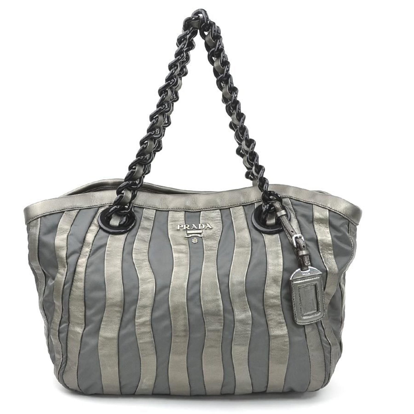 Handbag Nylon Leather by Prada: Handbag Nylon Leather by Prada Nylon and leather combine in a sleek, gray Prada handbag with a subtle sheen. Measuring 27.5cm x 44cm x 14cm, it features a classic design that has been well-loved but r