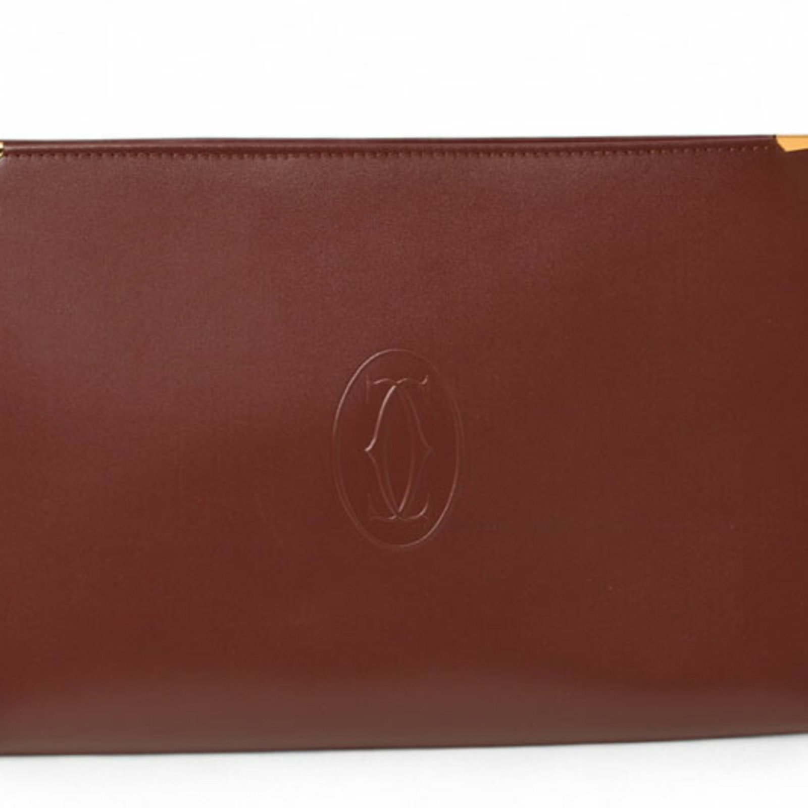 Cartier bag clutch leather: Cartier bag clutch leather Bordeaux leather Cartier bag clutch with a rich, luxurious feel. This used clutch boasts a classic design and premium materials, showcasing a few subtle signs of wear that