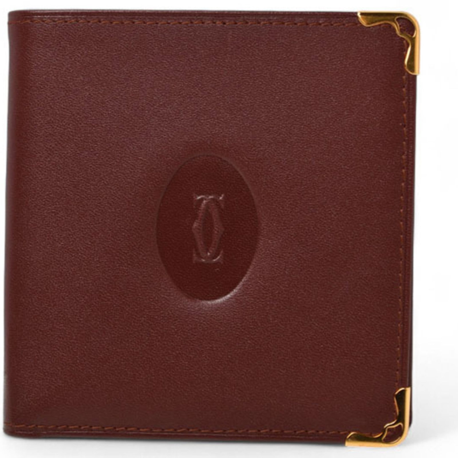 Cartier wallet bi fold: Cartier wallet bi fold Bordeaux leather Cartier bi-fold wallet, featuring an open snap fastener closure and classic design. The used condition shows some traces of usage with minor scratches and