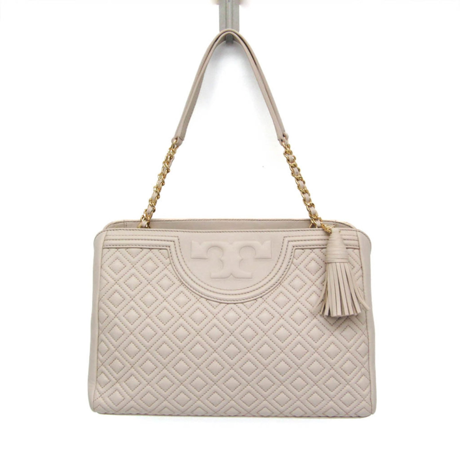 Leather tote bag from Tory Burch: Leather tote bag from Tory Burch Light pink leather tote bag from Tory Burch, featuring a zipper pocket and snap pockets for added functionality. The bag's classic design is complemented by its durabl