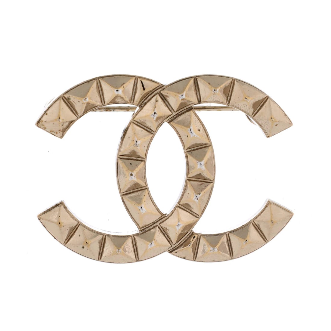 CC Stud Brooch Metal By Chanel: CC Stud Brooch Metal By Chanel The CC Stud Brooch Metal by Chanel boasts a striking gold exterior, measuring 1.25" in height and 1.5" in width. This metal brooch features minor scratches and wear